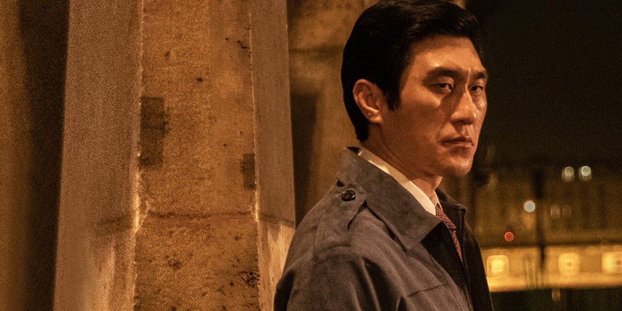 The Man Standing Next backdrop